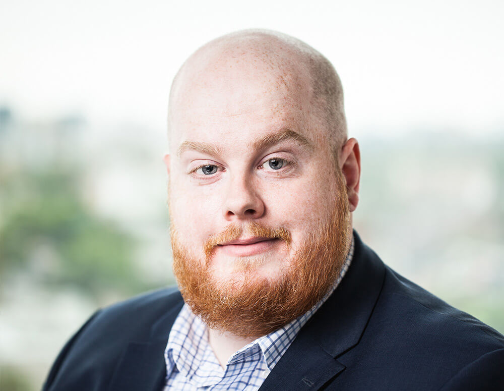 A man with a beard smiling at the camera.